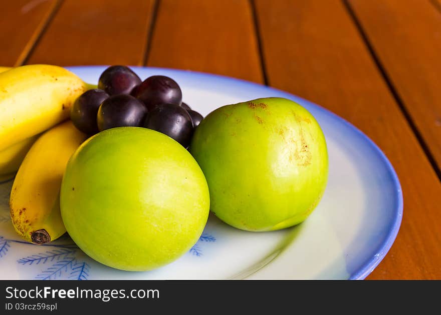 Tropical fruits on wood table