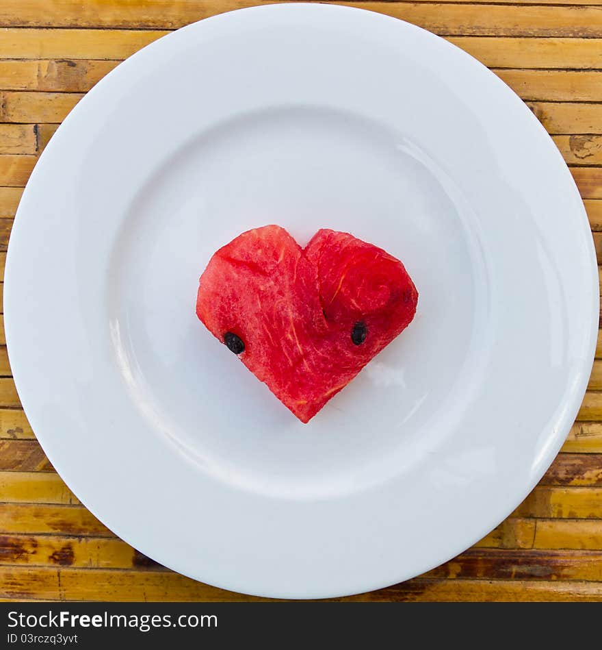 Heart shape watermelon on white dish