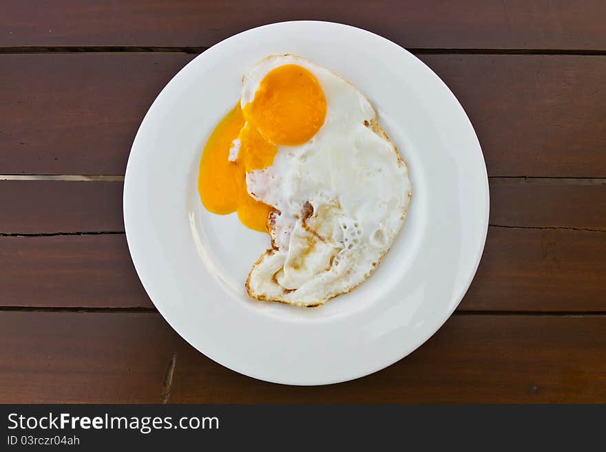 Fried egg on wood table