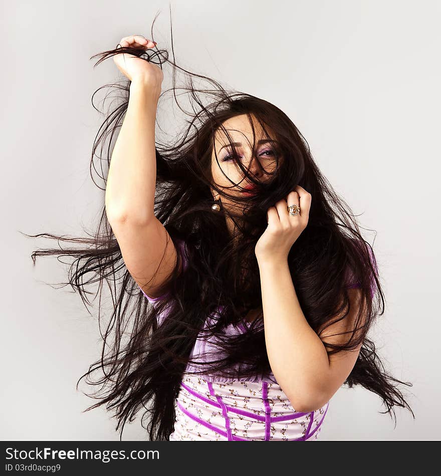 Portrait of a beautiful brunette woman with wonderful waving hair. Portrait of a beautiful brunette woman with wonderful waving hair.