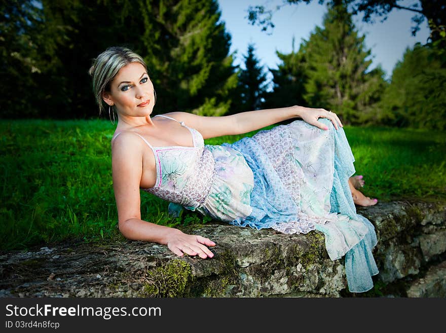 Attractive Woman Lying On Stones