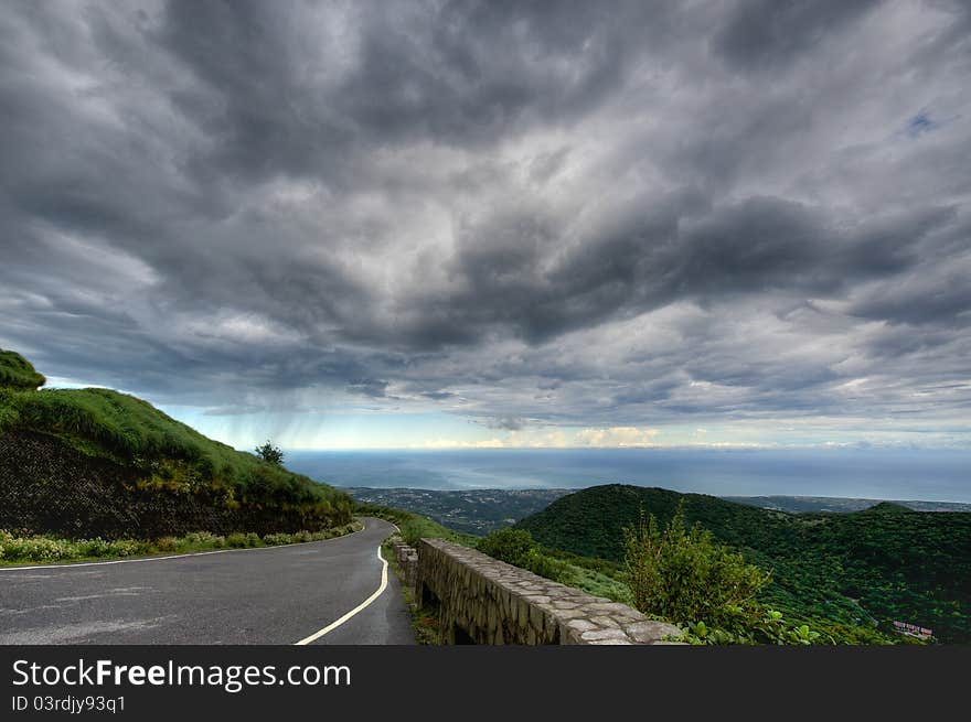 Road in the mountains at sky with clouds