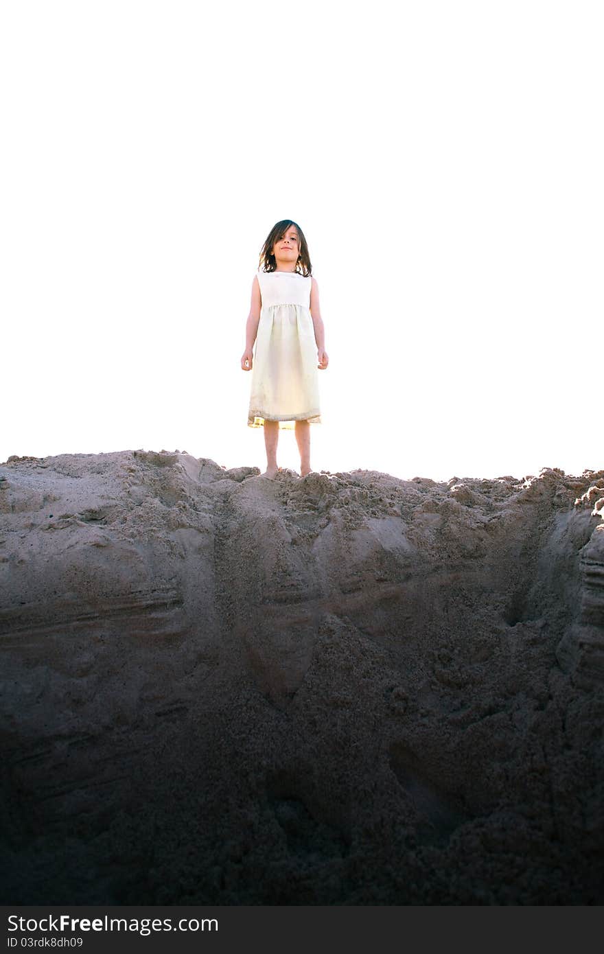 Girl stands on a hill of sand. Girl stands on a hill of sand