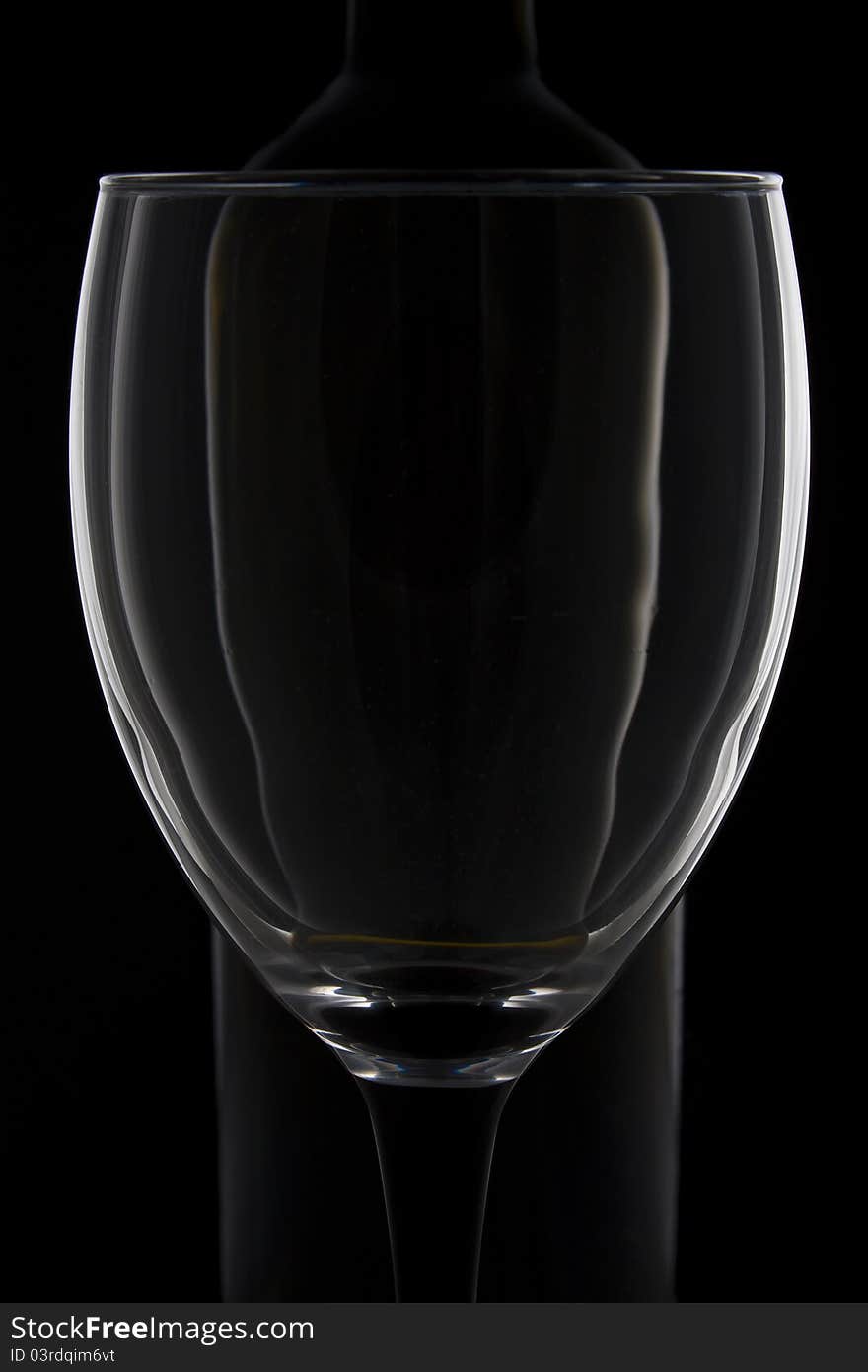 Impression of a wine glass and wine bottle against a black background. Impression of a wine glass and wine bottle against a black background