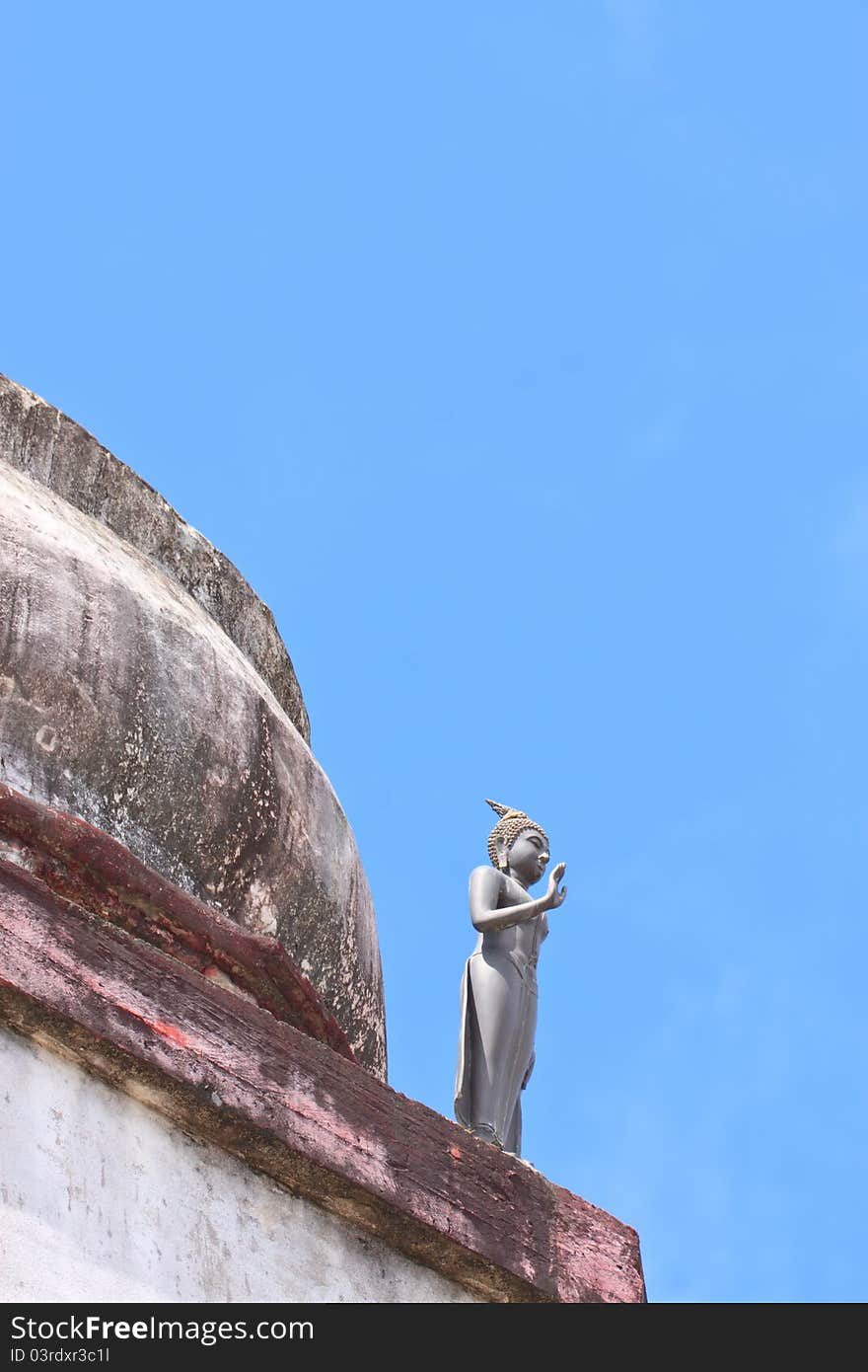 Budha statue standing on old sa-tup with blue sky. Budha statue standing on old sa-tup with blue sky