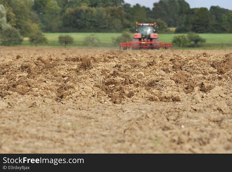 Plowed with tractor in background. Plowed with tractor in background