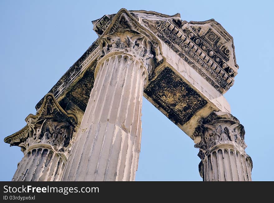 Antique portico against a blue sky. Rome, Italy