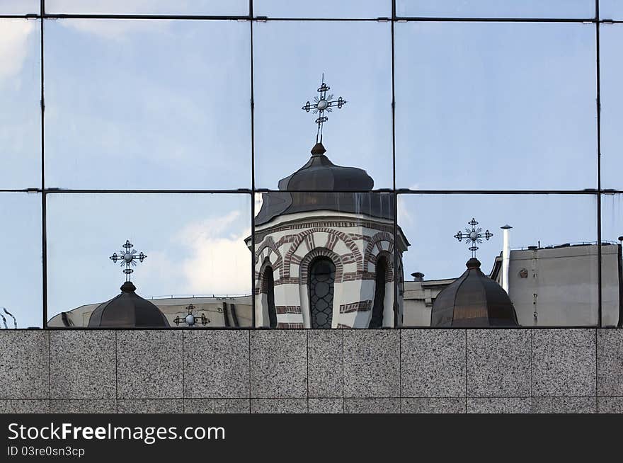 Orthodox church reflected in the windows of a modern building. Orthodox church reflected in the windows of a modern building