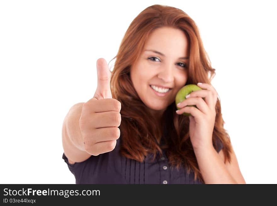 Young woman with green apple and showing thumb up, isolated over white