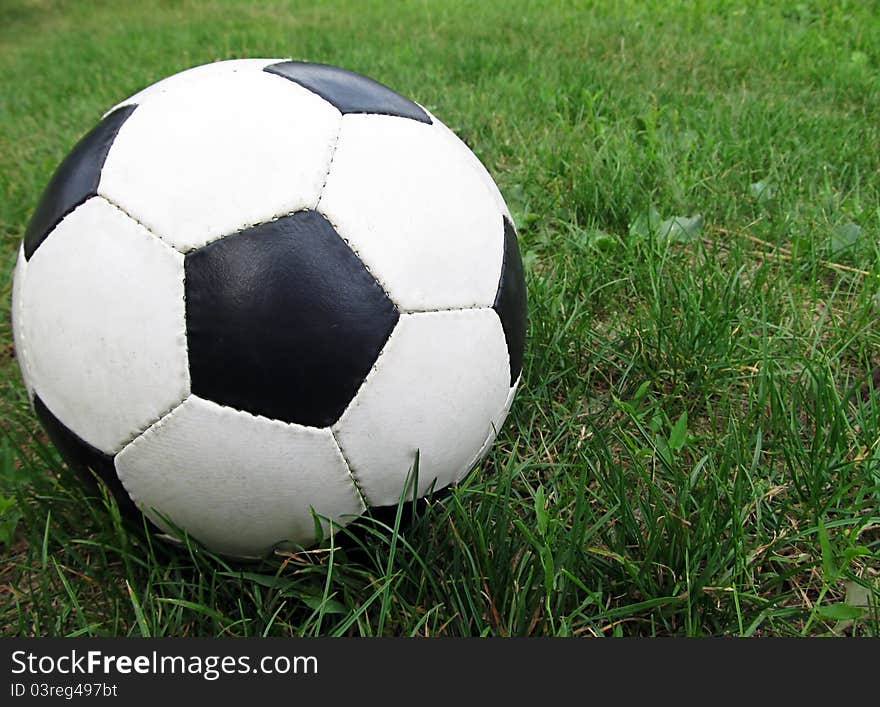 A ball lying on a green grass. A ball lying on a green grass