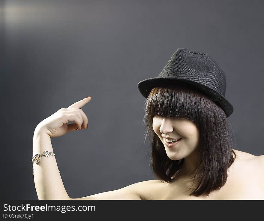 Portrait of a beautiful young woman in black hat. Portrait of a beautiful young woman in black hat