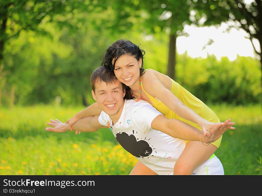 Young Couple Enjoying Backriding Outdoors