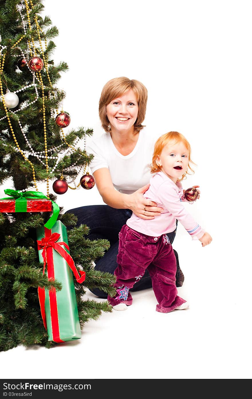 Mother with a son near a new-year tree on a white background