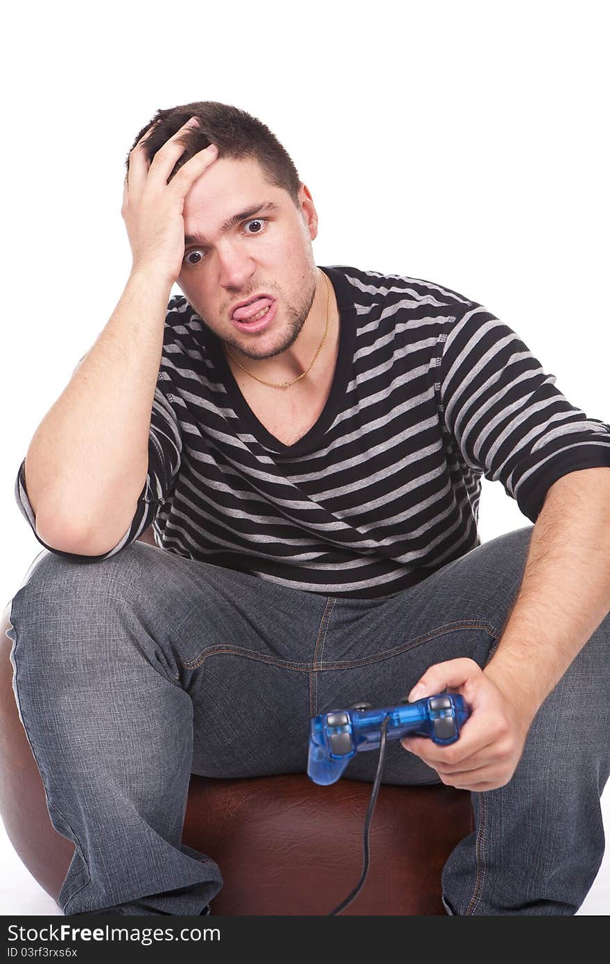 Young and furious man with a joystick for game console