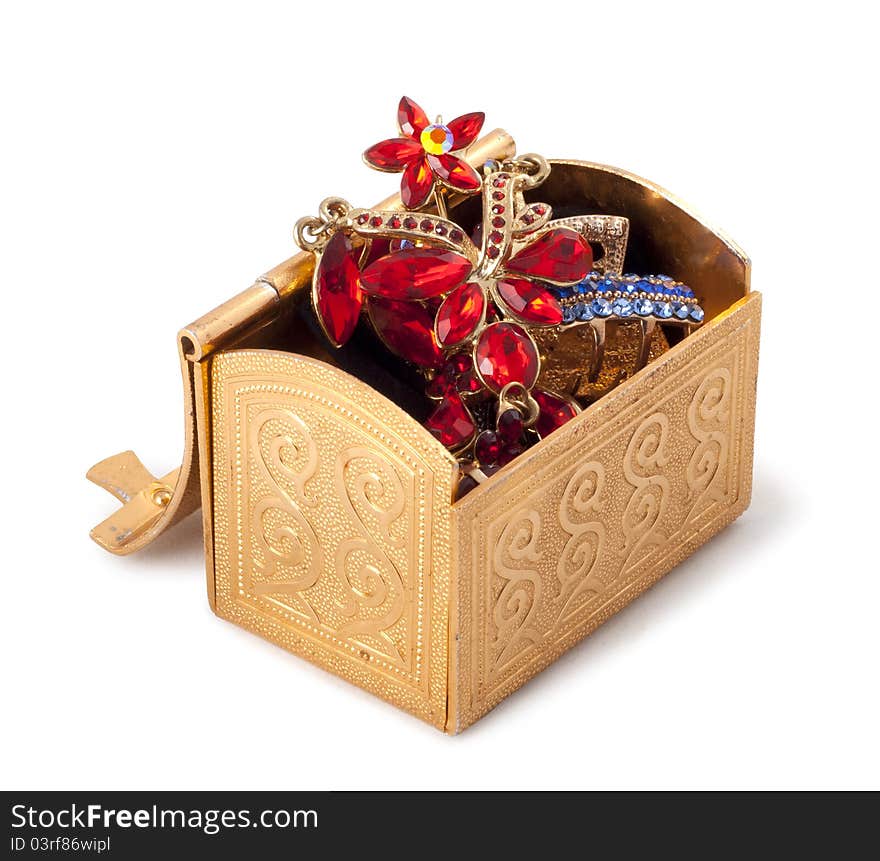 Gold metallic box with jewelry on a white background.