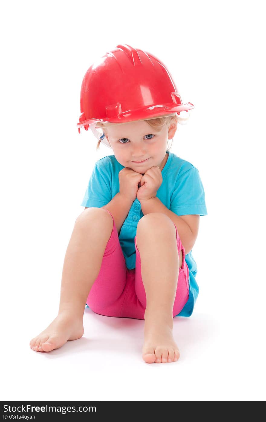 Little girl in the construction red helmet on head