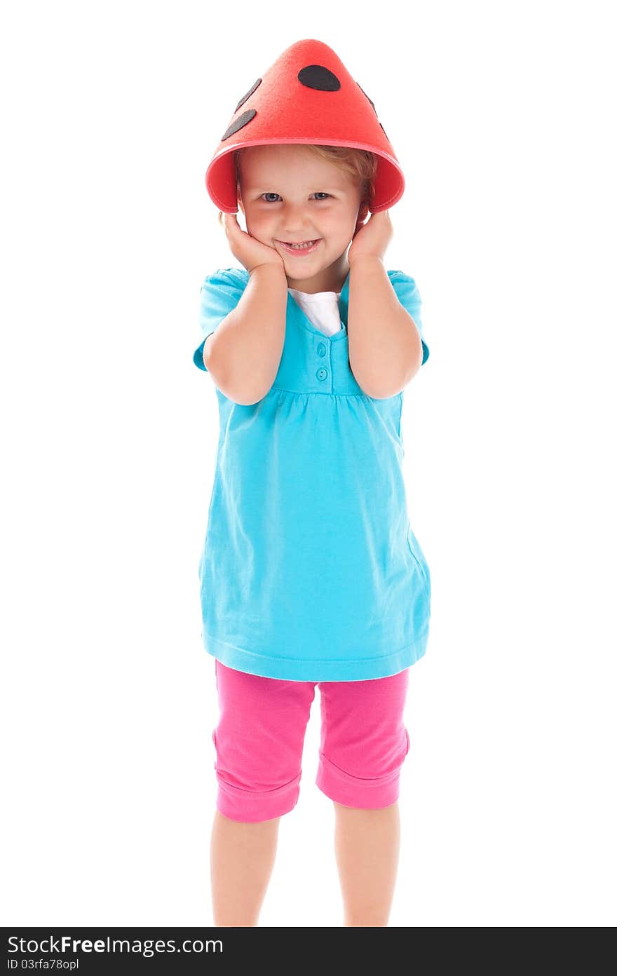 Little girl in studio in funny red hat on her head. Little girl in studio in funny red hat on her head