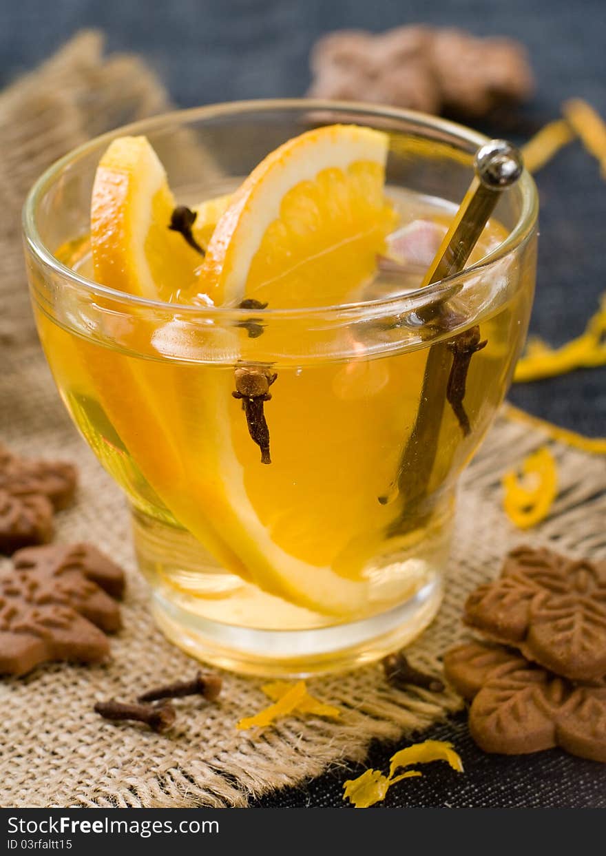 Hot orange drink with ginger cookies. Selective focus. Hot orange drink with ginger cookies. Selective focus