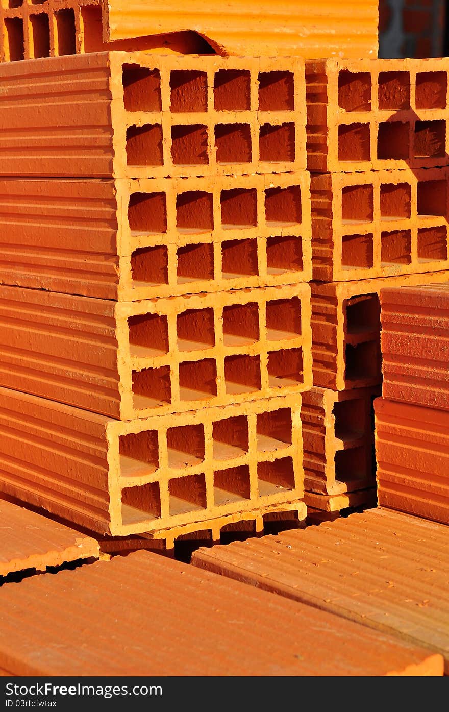 Pile of orange bricks used to build walls. Pile of orange bricks used to build walls