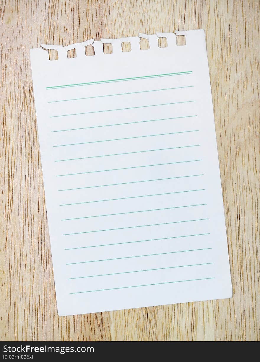 White paper, green lines on wood floor. White paper, green lines on wood floor