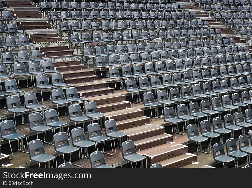 Plenty of grey seats arranged on temporary concert hall. Plenty of grey seats arranged on temporary concert hall