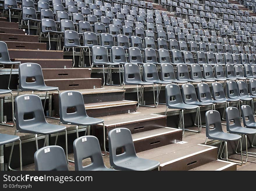 Plenty of  grey seats arranged on temporary hall. Plenty of  grey seats arranged on temporary hall