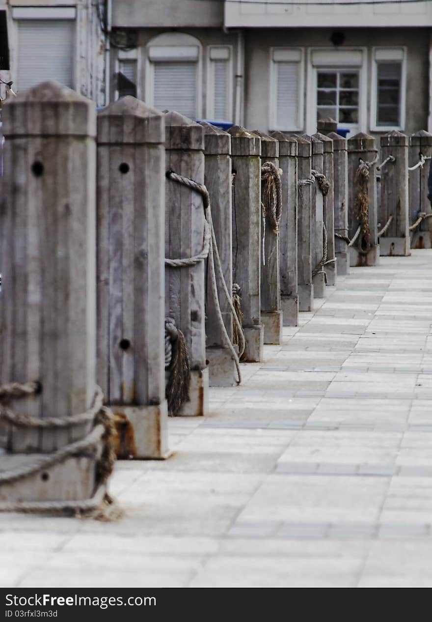 Vertical portrait of quayside wharf in Istanbul, berths bollards quays and public footpath, crop space and copy area. Vertical portrait of quayside wharf in Istanbul, berths bollards quays and public footpath, crop space and copy area