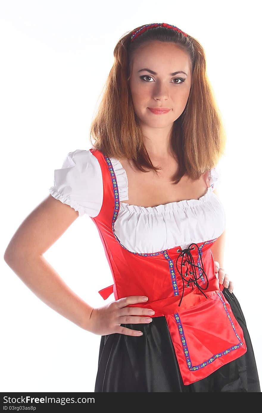 The girl in a traditional Bavarian dress with full glasses of beer in hands