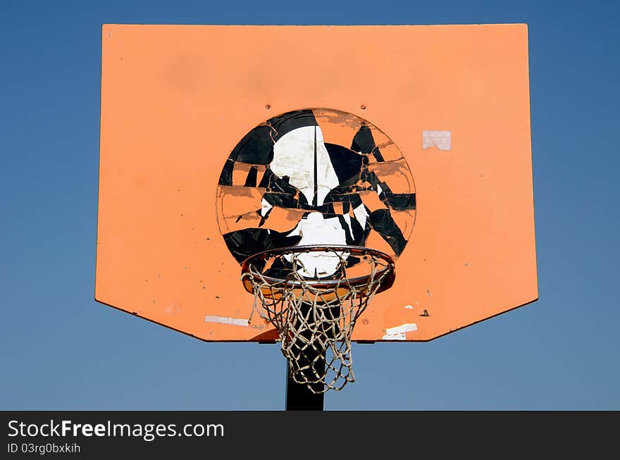 Orange and grunge basketball backboard and sky background