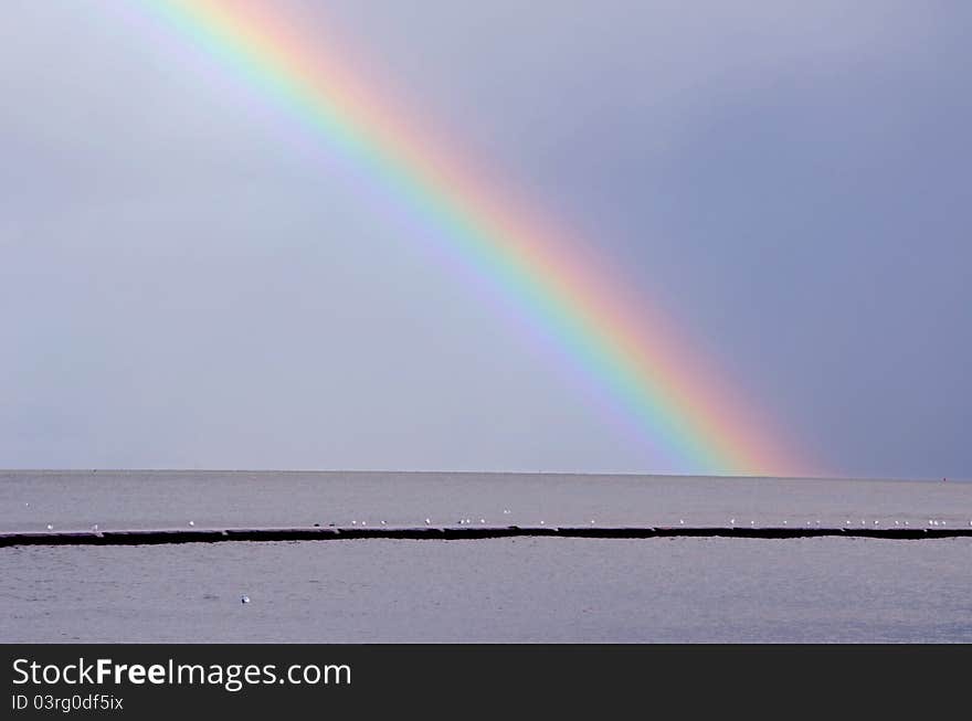 Autumn rainbow and rain in the bay