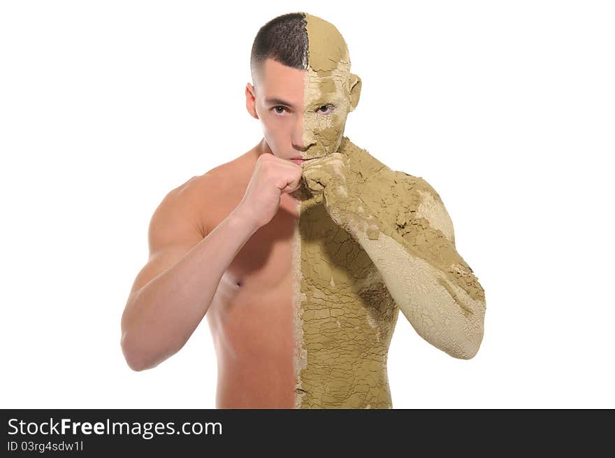 Young man half smeared with clay