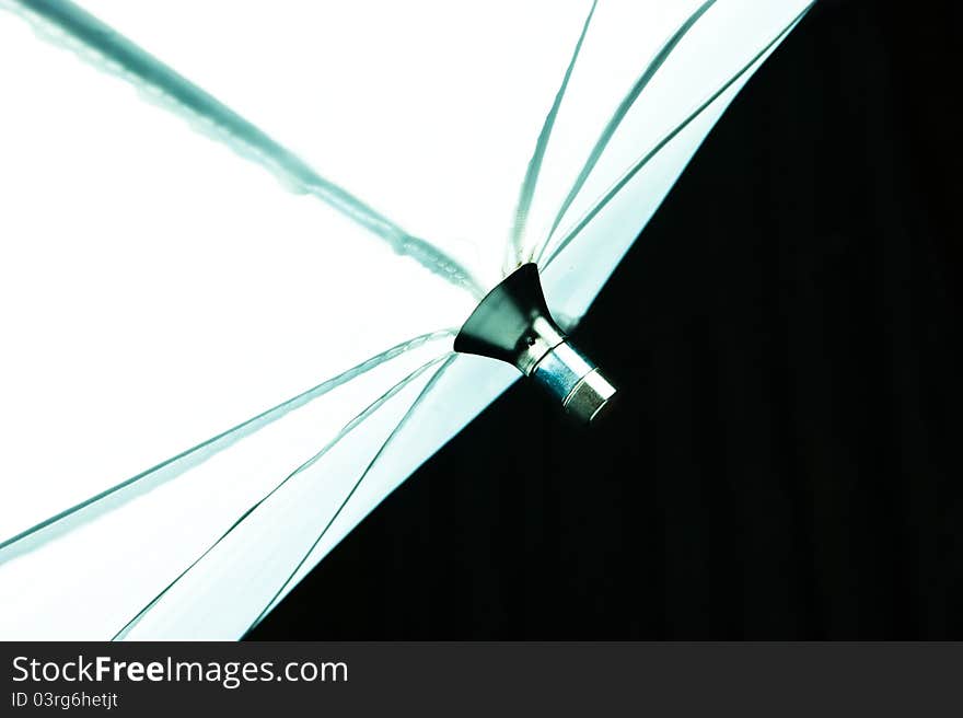 Lighting white umbrella soft box on a dark background