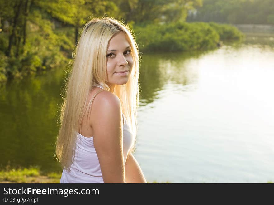 Attractive blonde with lovely makeup on green background. Great pic for advertising. Attractive blonde with lovely makeup on green background. Great pic for advertising