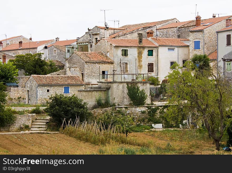 Old stone houses with colorful blue windows. Old stone houses with colorful blue windows