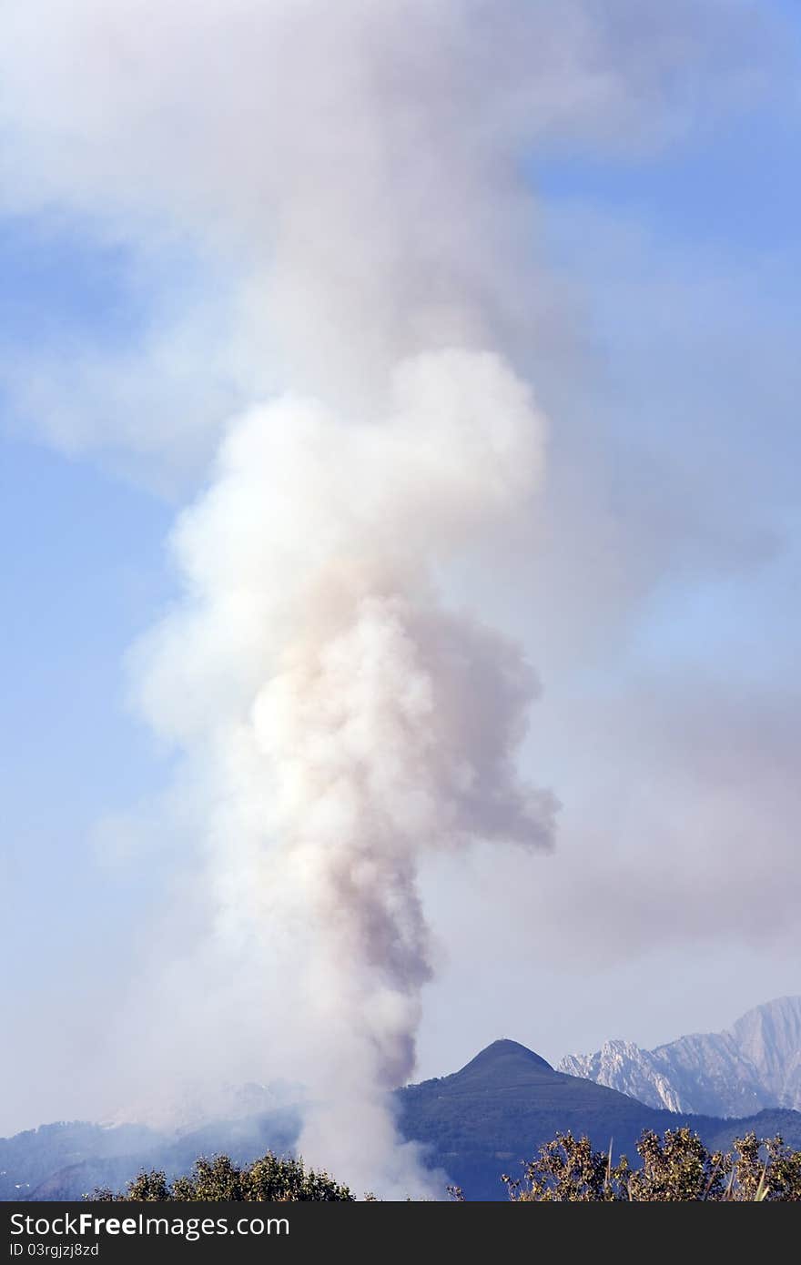 Smoke from a fire in the mountains of italian north