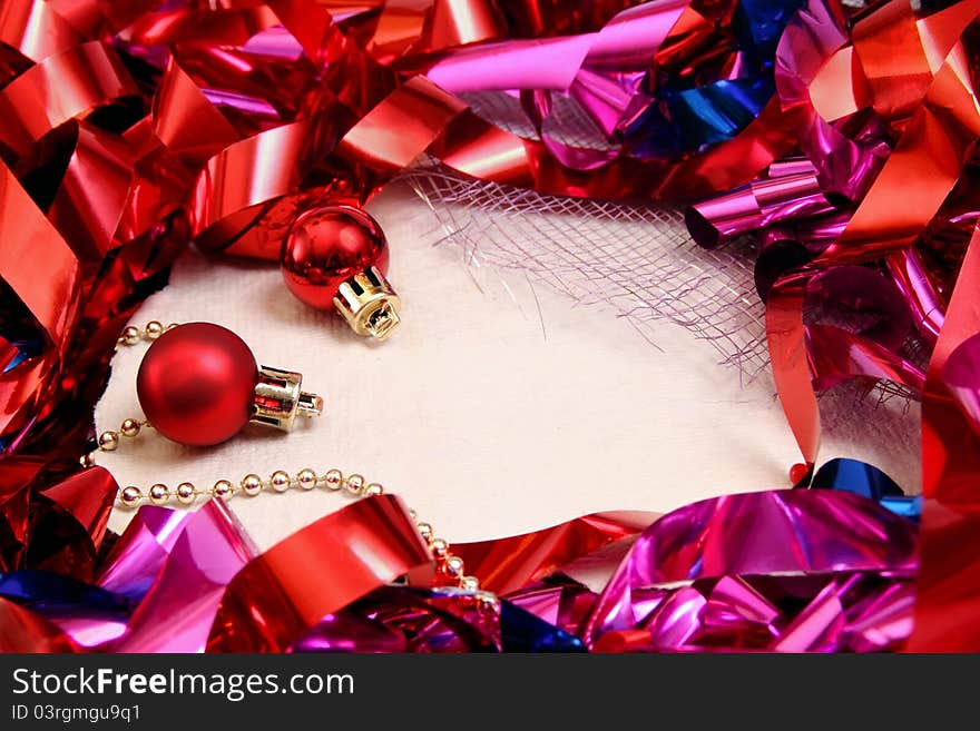 Background for notes with shiny Christmas tinsel and decorations. Background for notes with shiny Christmas tinsel and decorations