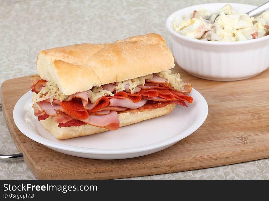 Ham, pepperoni and bacon sandwich on a plate