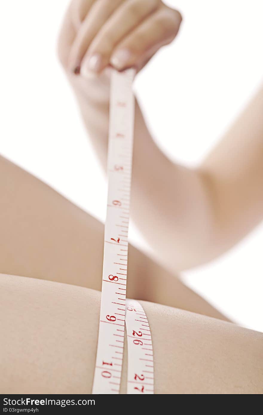 Close-up of a woman measuring her leg