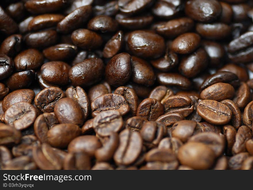 Decaffinated and caffinated coffee beans piled next to each other. Decaffinated and caffinated coffee beans piled next to each other.