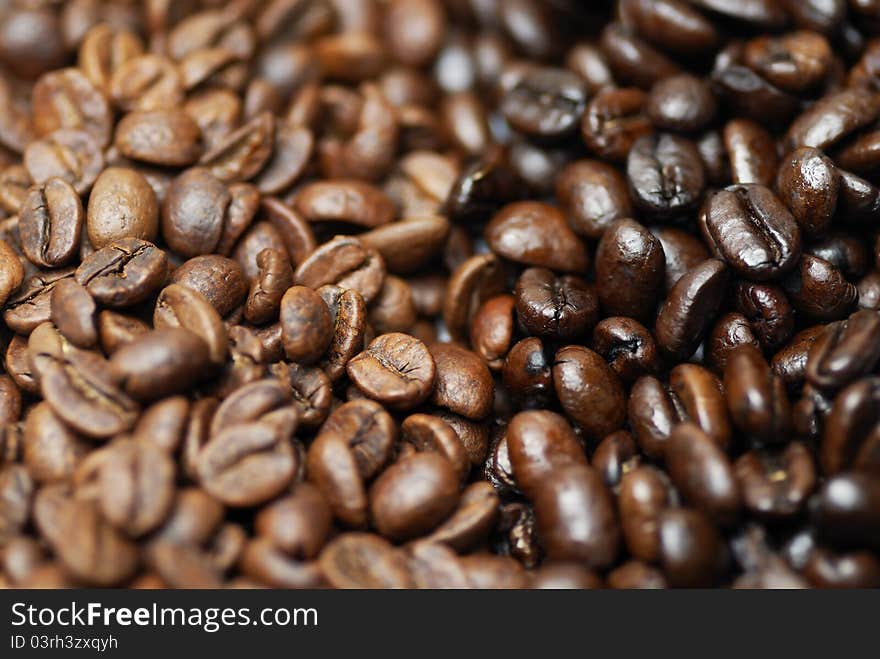 Decaffinated and caffinated coffee beans piled next to each other. Decaffinated and caffinated coffee beans piled next to each other.