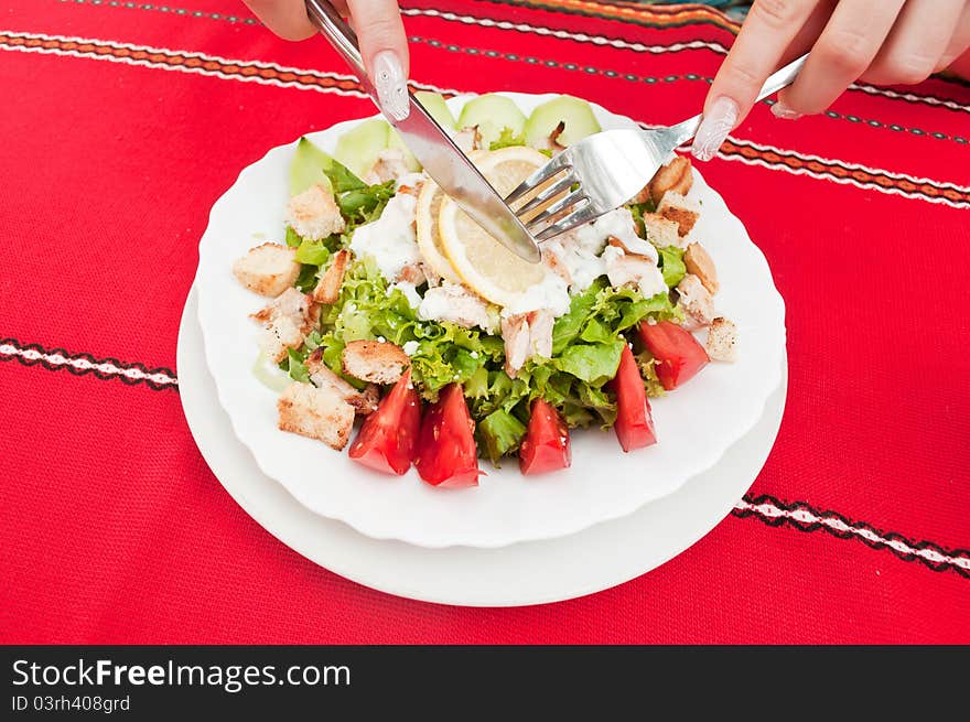 Girl in a restaurant eating Caesar salad. Girl in a restaurant eating Caesar salad