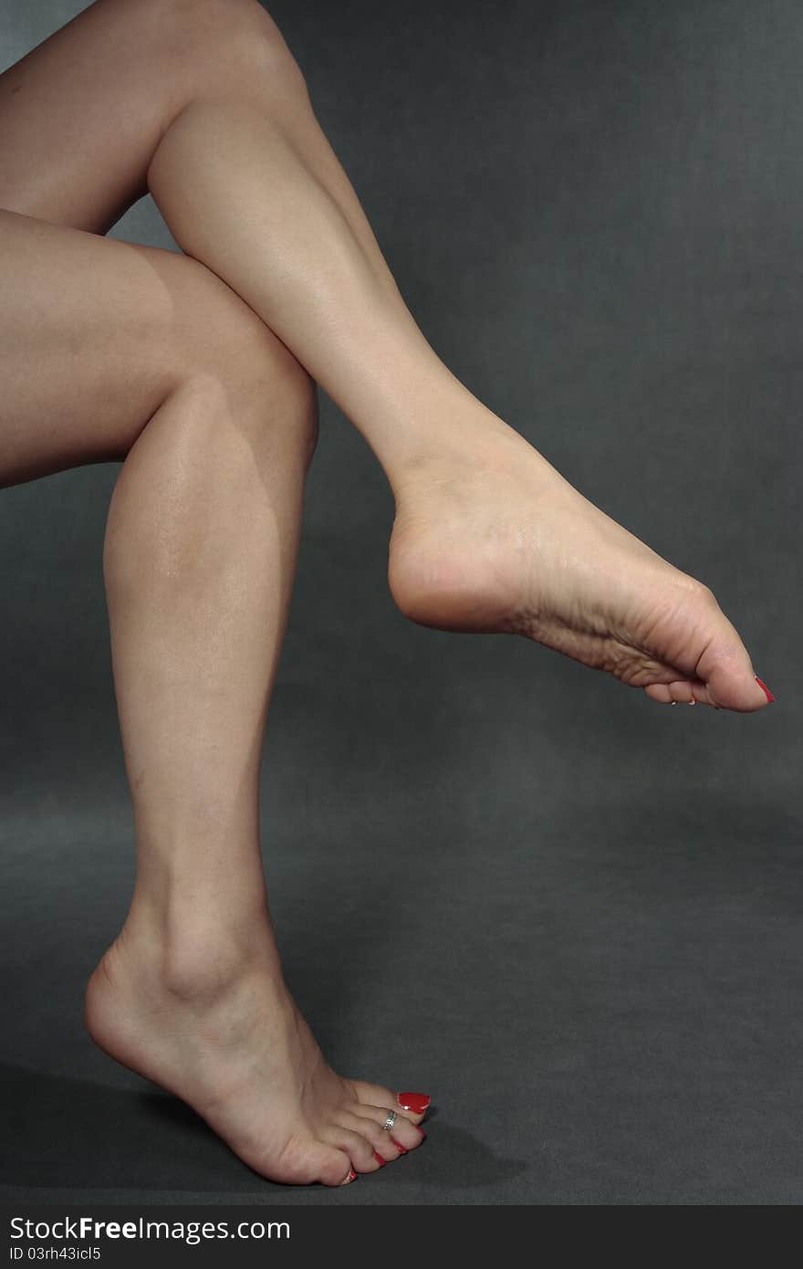 Woman feet  over grey