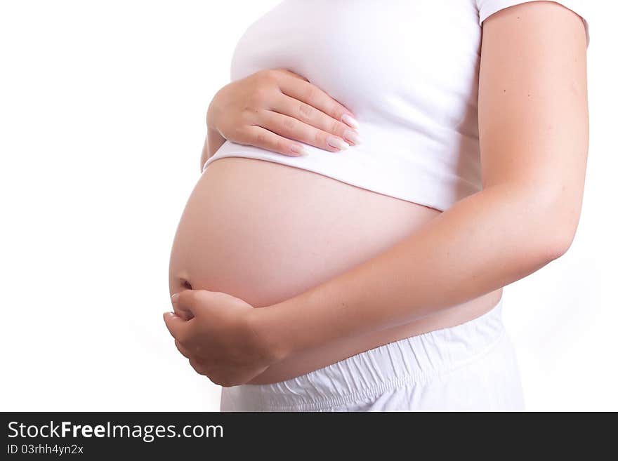 Pregnant woman touching her belly with hands