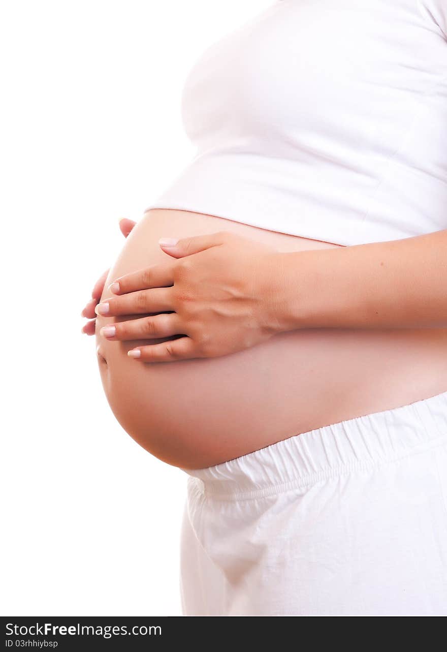 Pregnant woman touching her belly with hands