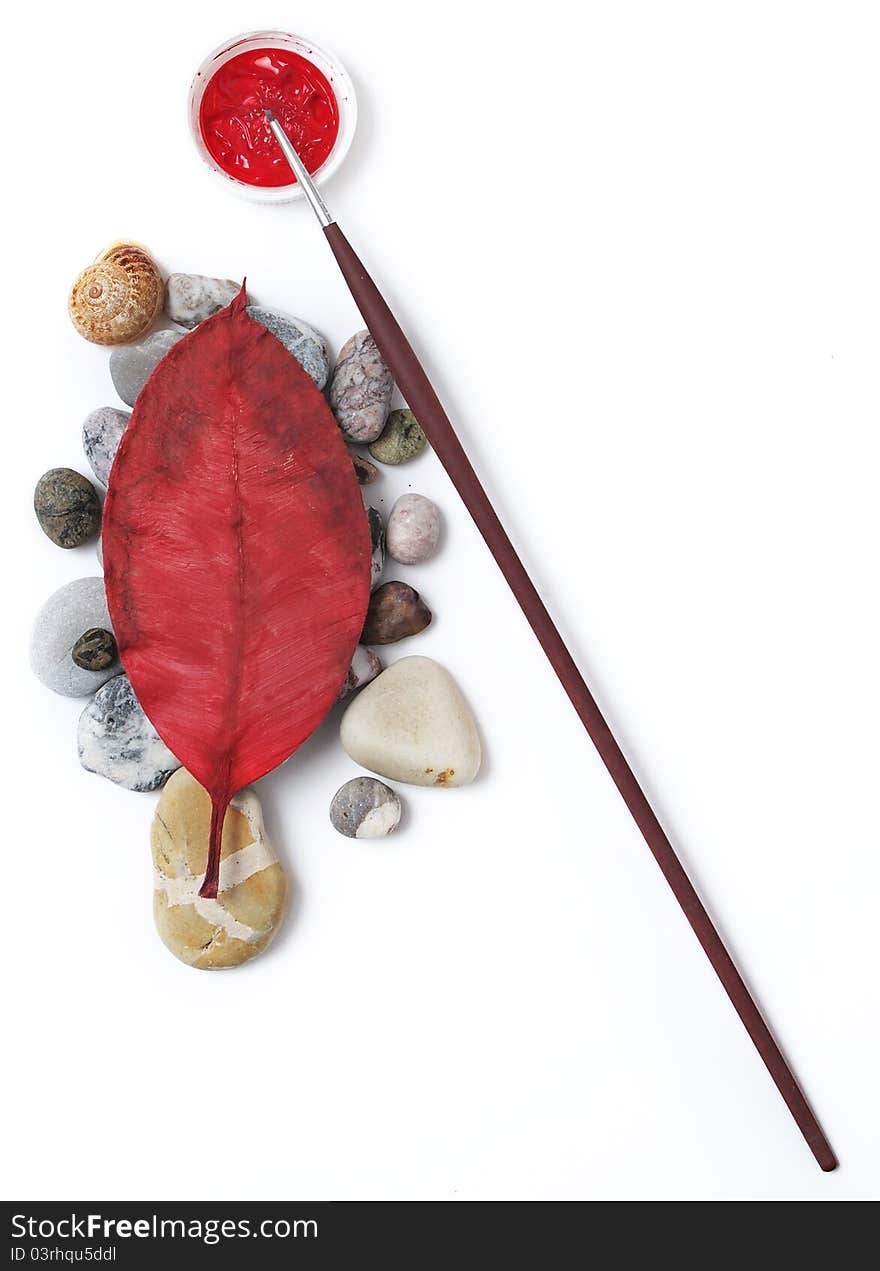 Artist's brush and red leaf