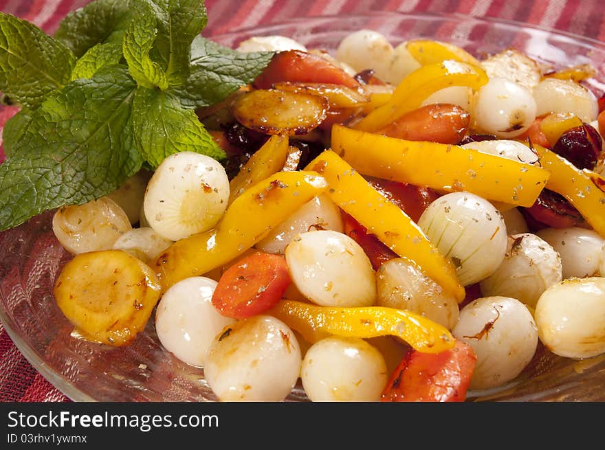 Colorful roasted onions peppers and carrots in a glass dish. Colorful roasted onions peppers and carrots in a glass dish