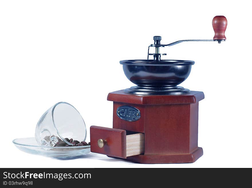 Coffee grinder  coffee beans and a glass cup on a white background. Coffee grinder  coffee beans and a glass cup on a white background