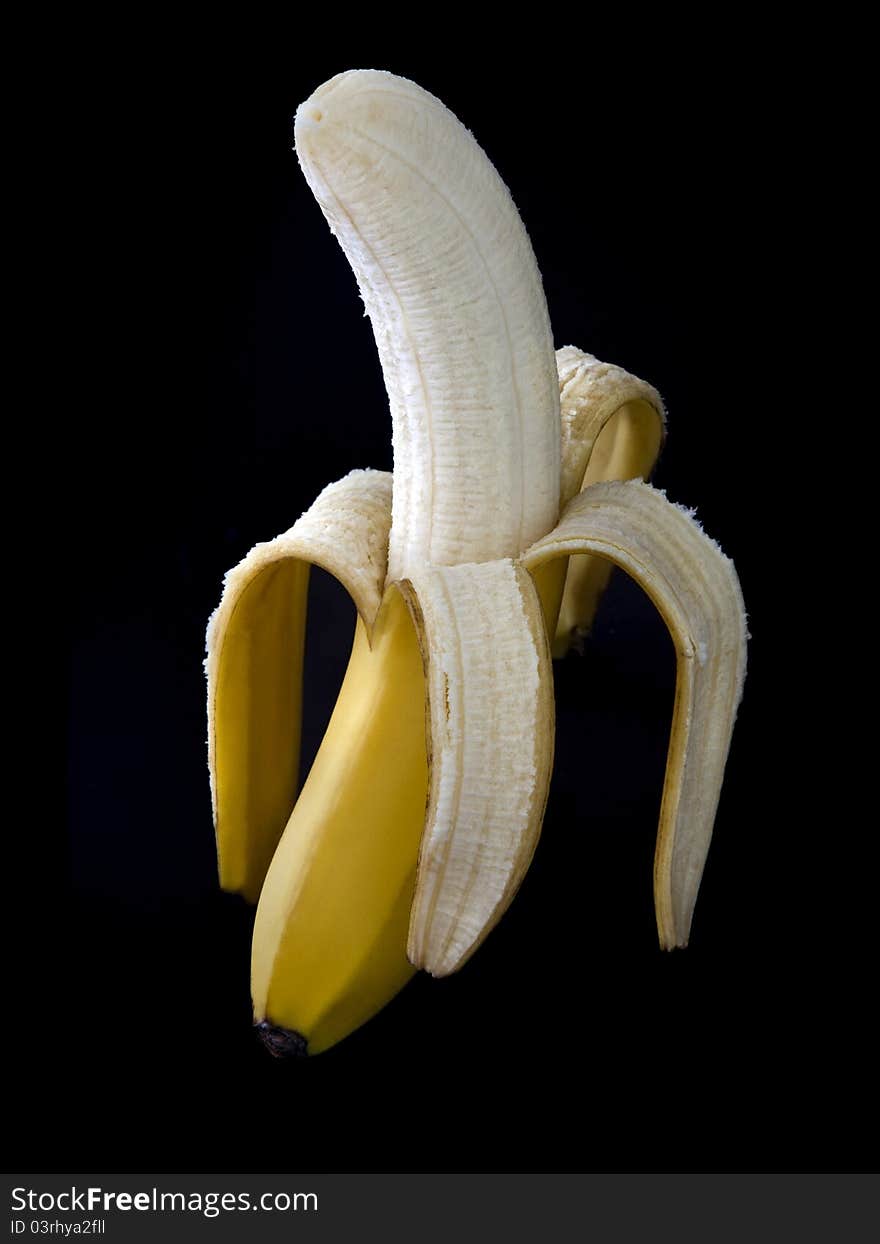 Peeled banana on a dark background