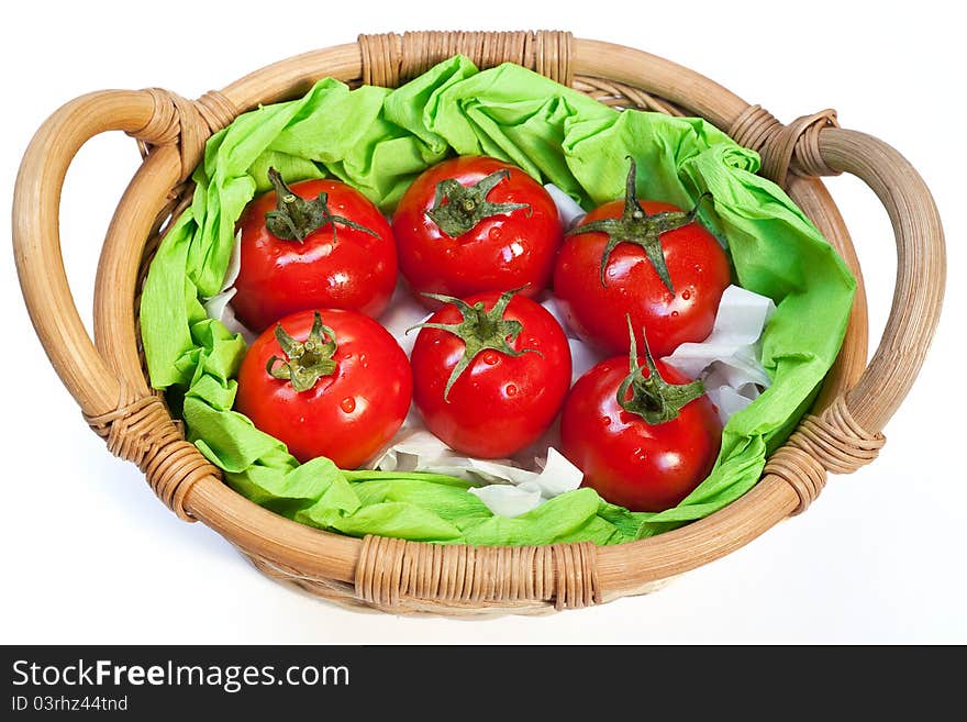 Red ripe tomatoes in the woven basket