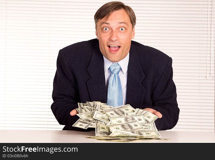 Portrait of a businessman with cash at office. Portrait of a businessman with cash at office